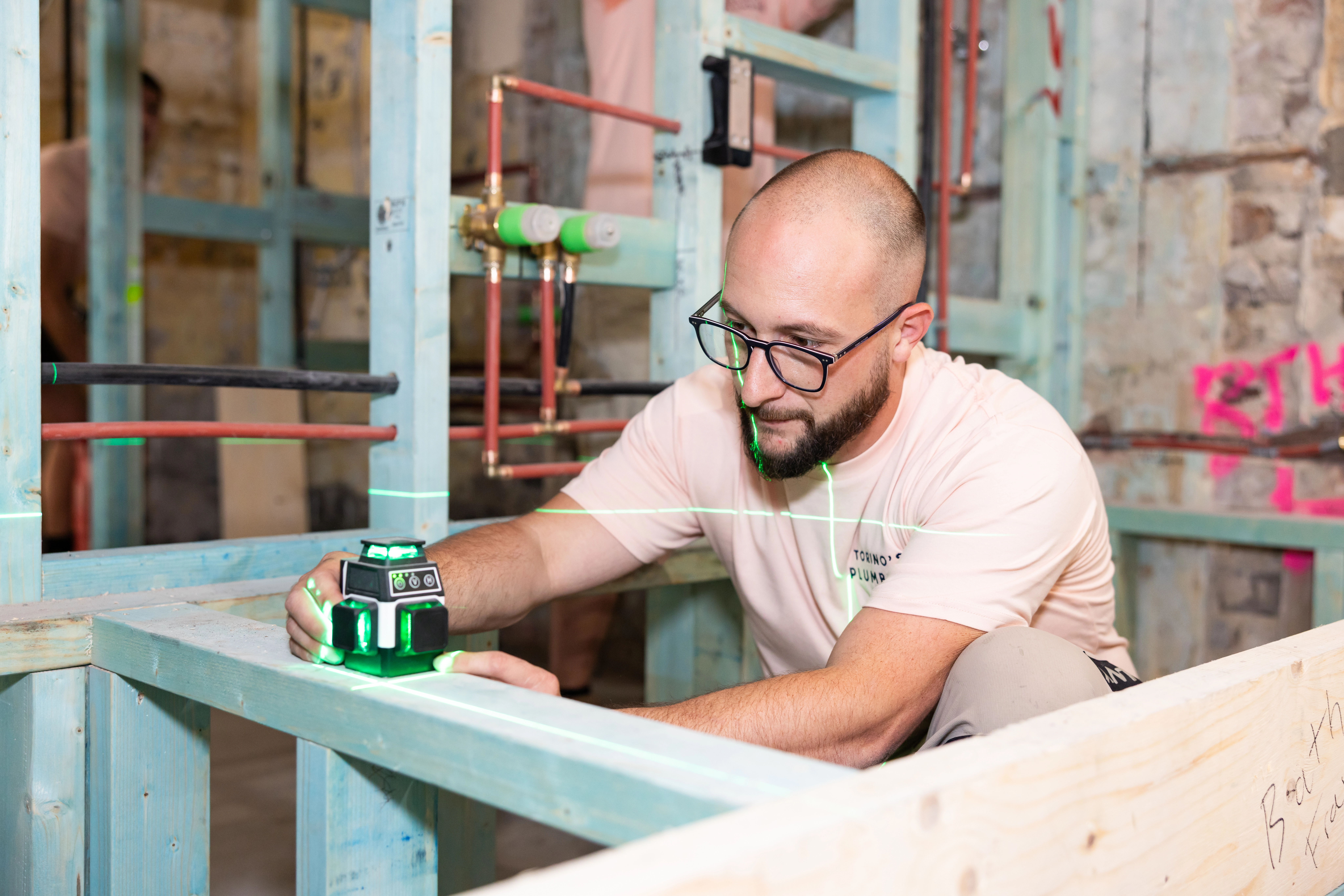 Technician measuring room dimensions with a tape measure